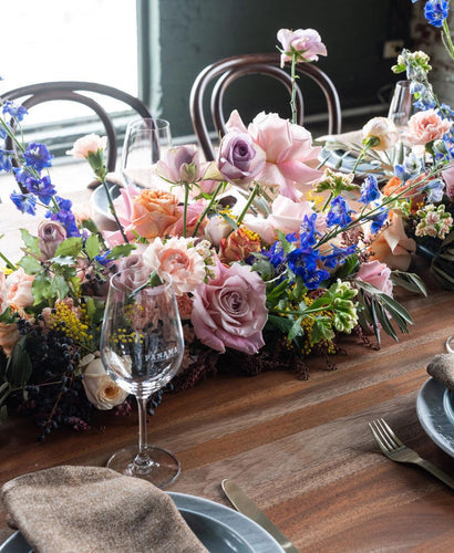 Elegant summer wedding table with vibrant floral centerpiece in Melbourne.