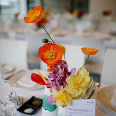 Wedding floral bud vase with orange poppies and anthurium 