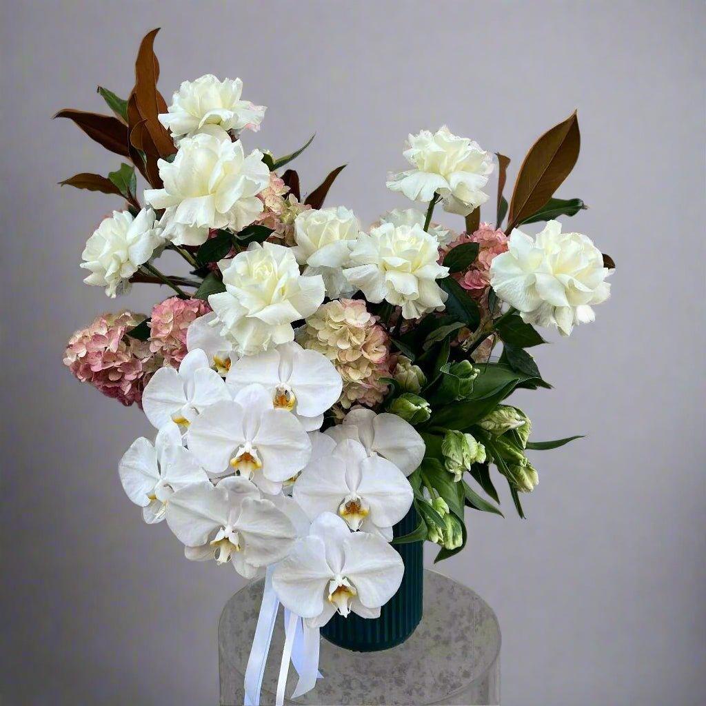 white rose bouquet with white orchids and pink hydrangea