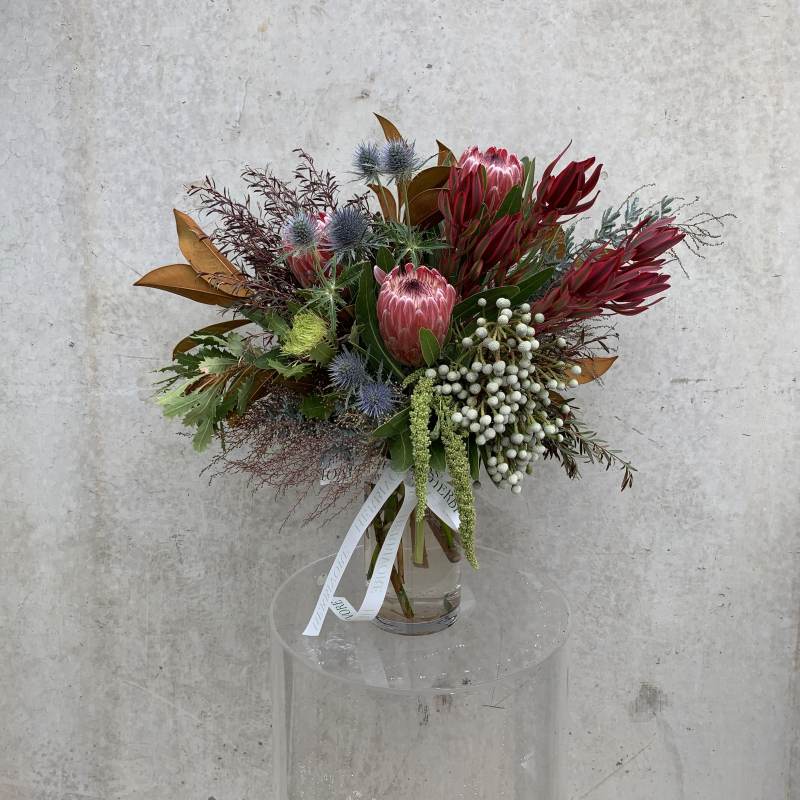 Small native floral bouquet in a glass vase at a florist in Yarraville