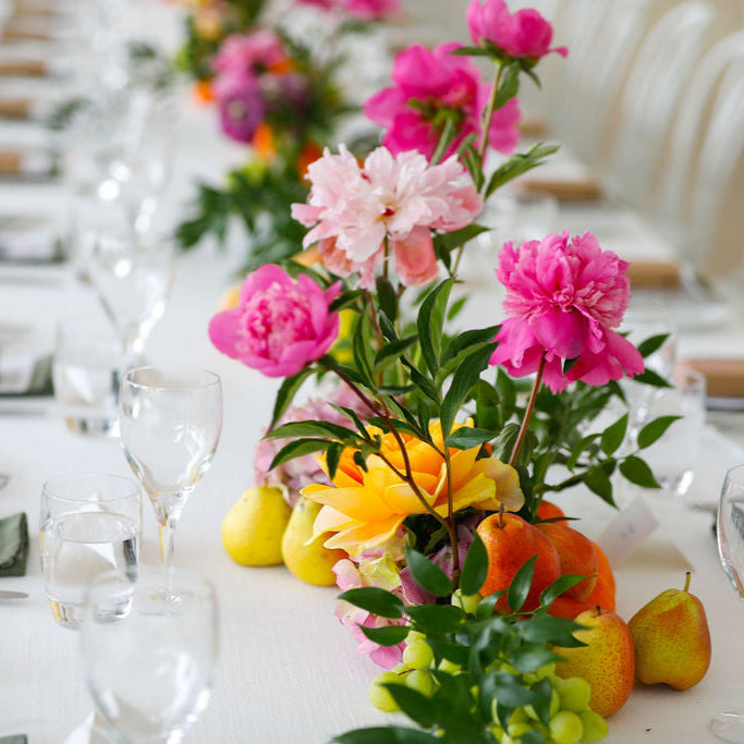 Pink and green wedding table arrangement with fruit