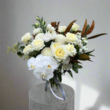 Flower arrangement with orchids and white roses. 