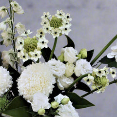 Close-up of a porcelain-inspired floral bouquet featuring white roses, chrysanthemums, and delicate seasonal flowers. Ideal for autumn florals and Mother's Day gifts.