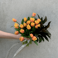 Large bouquet of orange tulips gift wrapped